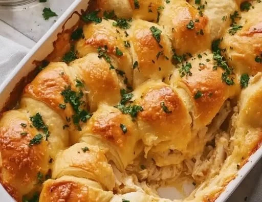 Cheesy chicken crescent roll bake in a casserole dish, ready to serve.