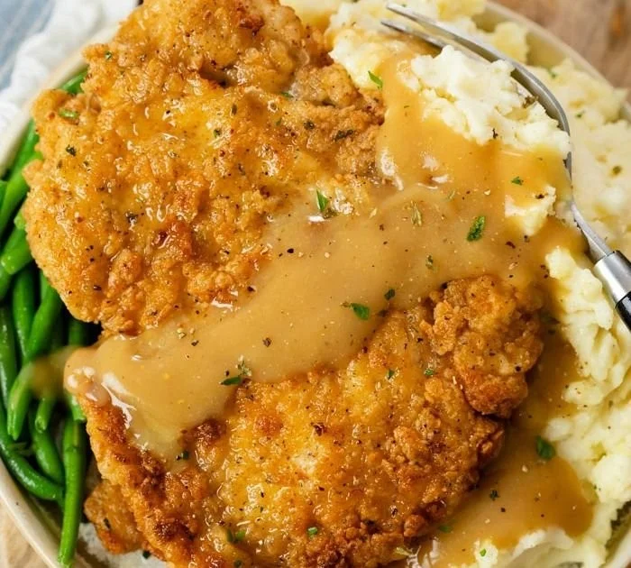 Crispy Country Fried Chicken Breast served on a plate with sides