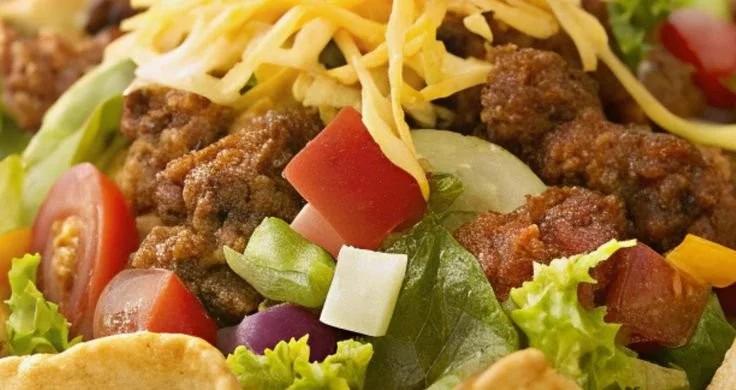 Crispy tortilla bowl filled with vibrant taco salad ingredients