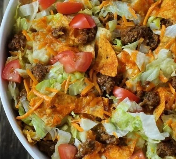 Delicious Doritos Taco Salad with colorful ingredients on a plate.