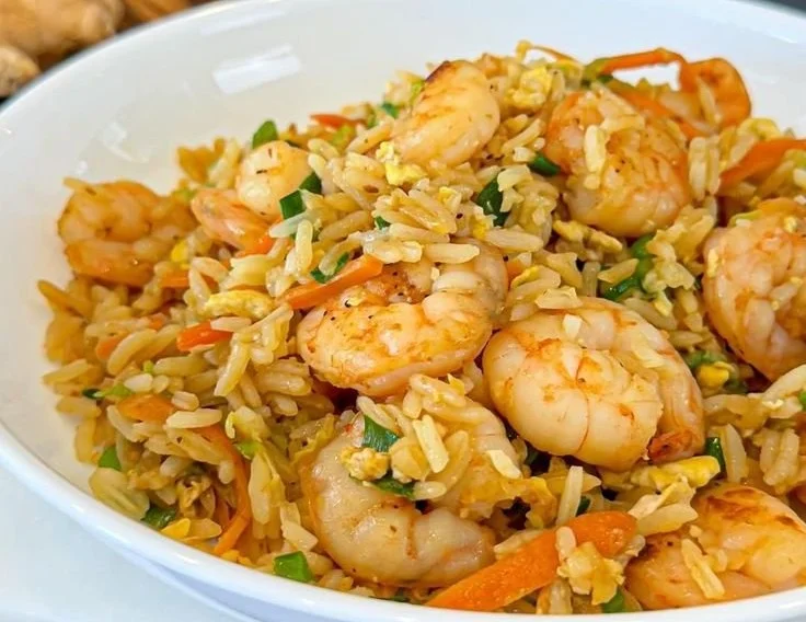 Bowl of colorful fried rice with vegetables and shrimp