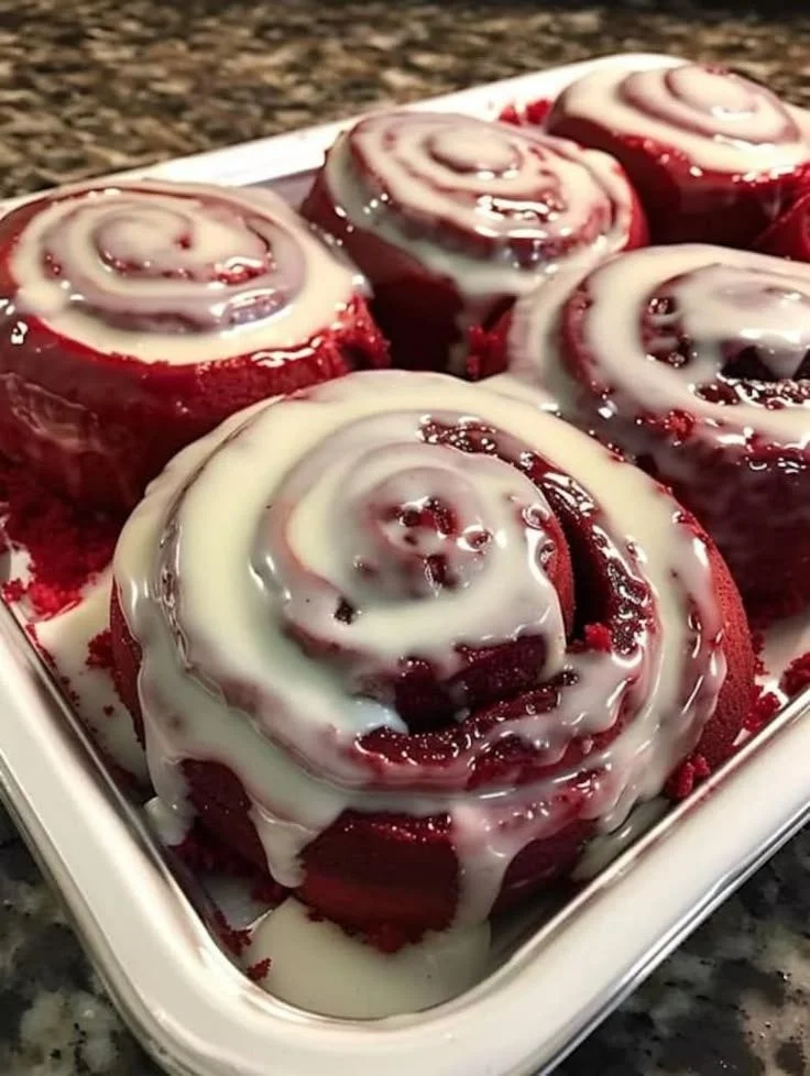 Heavenly red velvet cinnamon rolls topped with cream cheese icing