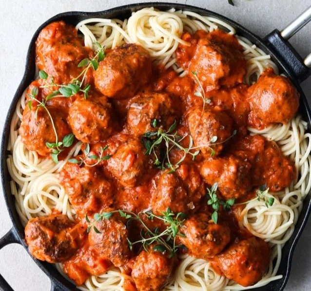 Italian meatballs simmering in a tomato sauce served on a plate