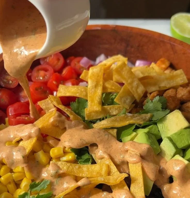 Vegan taco salad bowl topped with creamy chipotle dressing