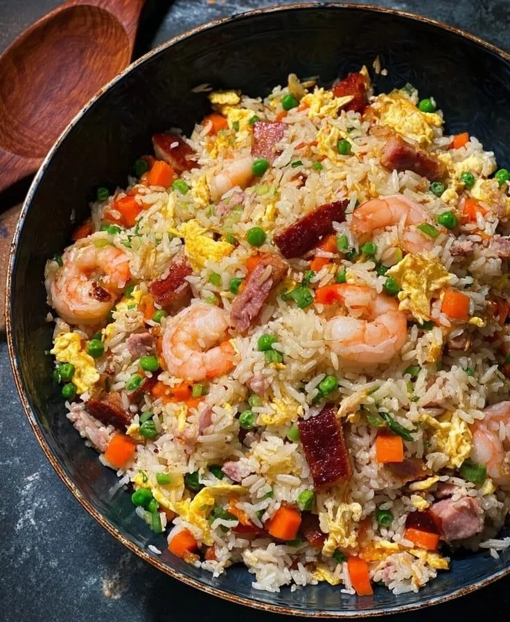 Delicious plate of Yangzhou Fried Rice garnished with vegetables and protein