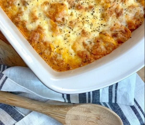Delicious cheesy baked tortellini casserole with meat sauce in a baking dish