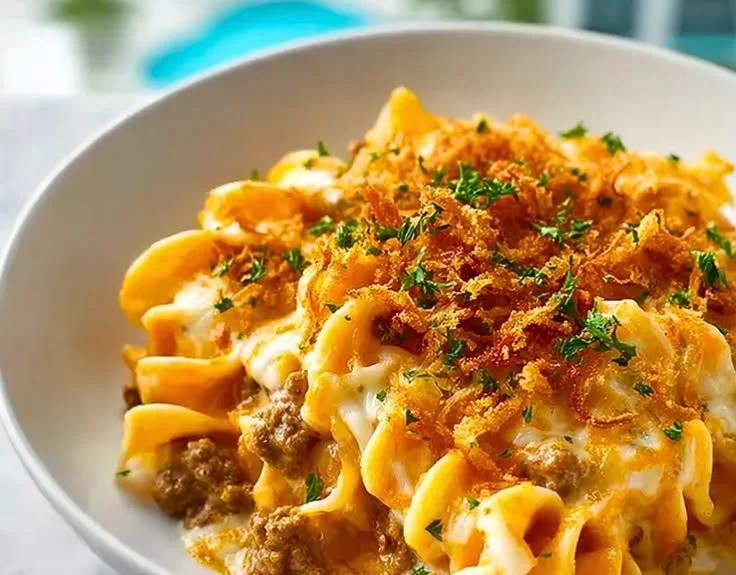 Delicious cheesy beef and noodle casserole garnished with herbs