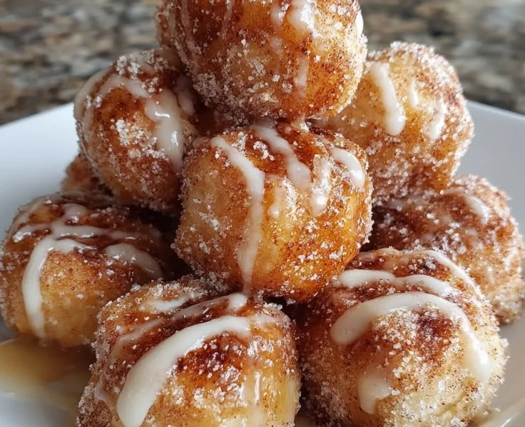 Bowl of freshly baked cinnamon sugar biscuit bites on a rustic table