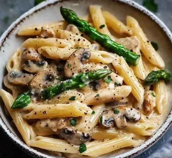 Creamy mushroom and asparagus chicken penne pasta dish with fresh ingredients