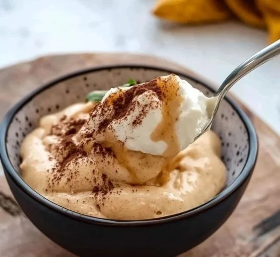 Creamy peanut butter powder blended with Greek yogurt in a bowl.
