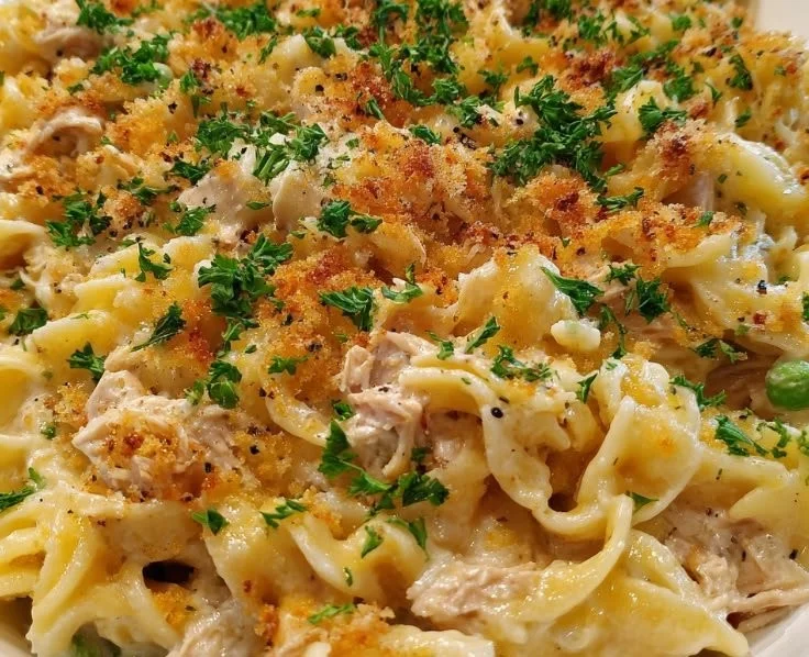 Creamy tuna noodle bake with pasta and flaky tuna in a casserole dish