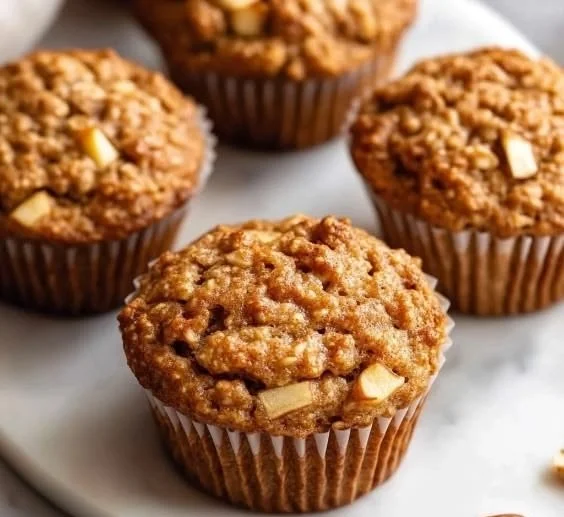 Healthy apple oat muffins with cinnamon on a wooden table
