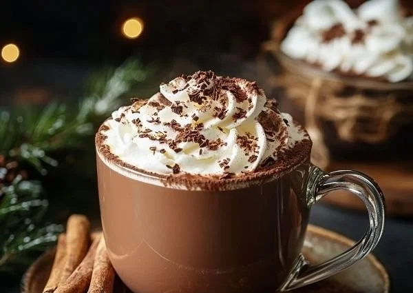 Delicious hot cocoa topped with whipped cream and chocolate sprinkles