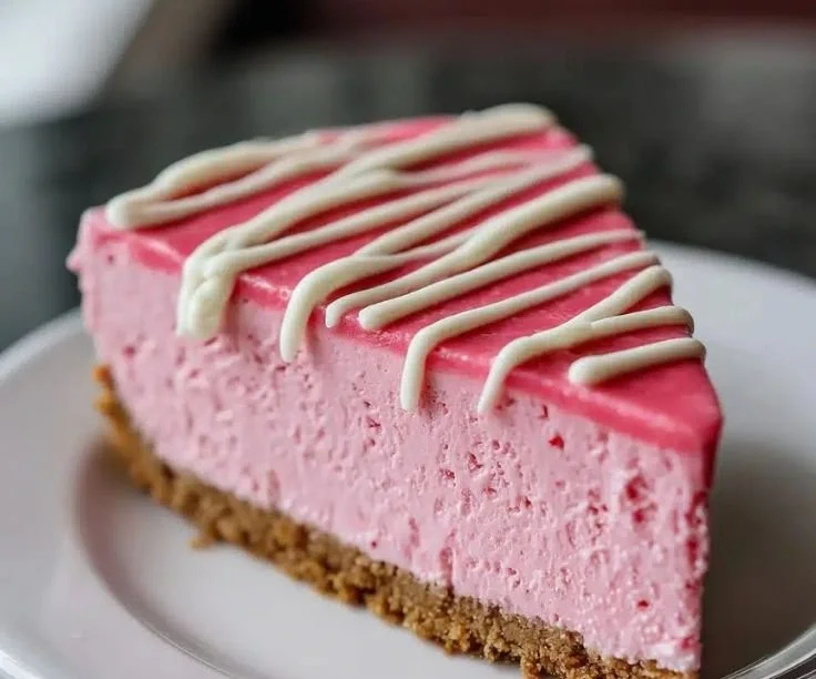 Delicious no-bake pink velvet cheesecake topped with fresh berries.