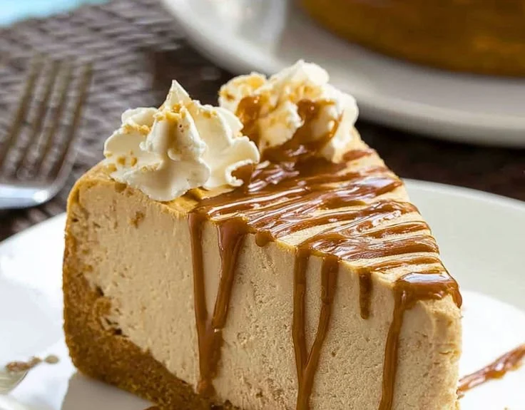 Delicious slice of Peanut Butter Cheesecake topped with chocolate drizzle