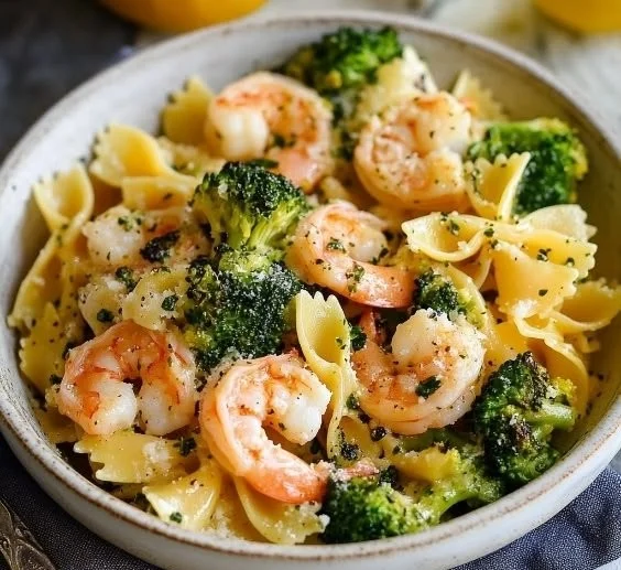 Plate of Shrimp and Broccoli Farfalle Pasta garnished with herbs