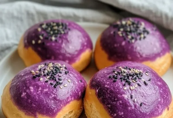Soft purple sweet potato buns fresh out of the oven, fluffy and colorful.