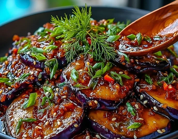 Delicious sticky garlic eggplant served in a bowl, showcasing rich flavors and textures.