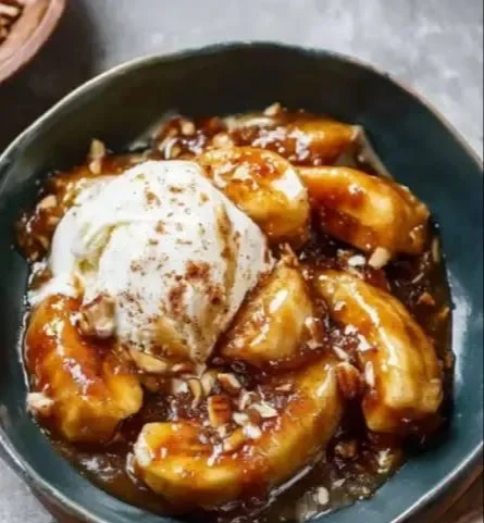 Delicious Bananas Foster dessert topped with caramel sauce and ice cream.