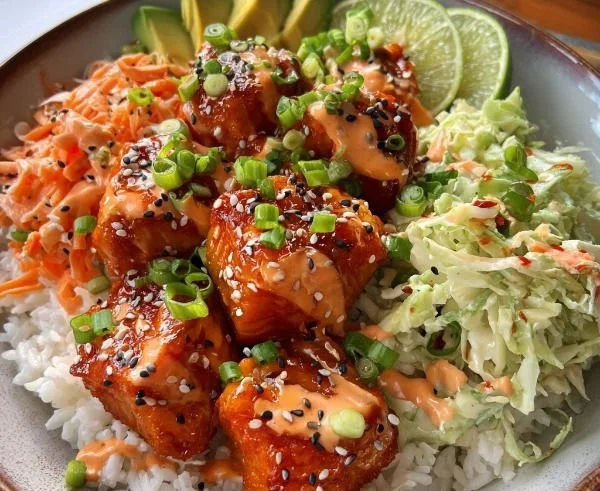 Delicious Bang Bang Salmon Bites served in a bowl with colorful vegetables