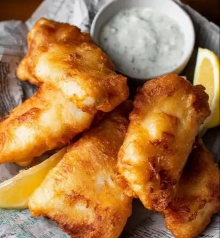 Crispy beer-battered fish served with lemon and tartar sauce