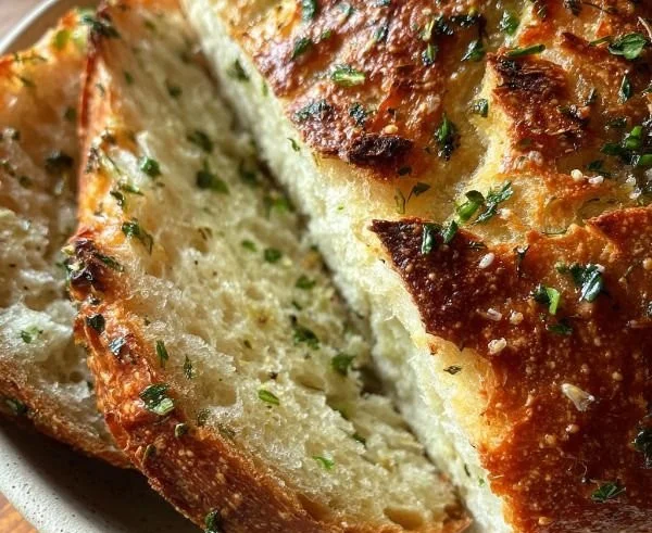 Freshly baked Garlic Herb Dutch Oven Bread with a crispy crust