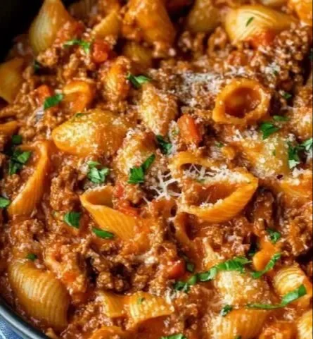 One-Pot Creamy Bolognese Pasta in a bowl topped with herbs