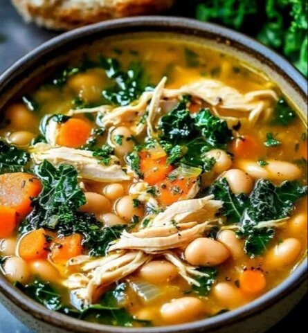 Bowl of hearty Tuscan-Style Chicken Soup with vegetables and herbs