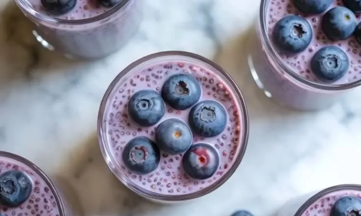 Delicious blueberry chia seed pudding garnished with fresh blueberries and mint.
