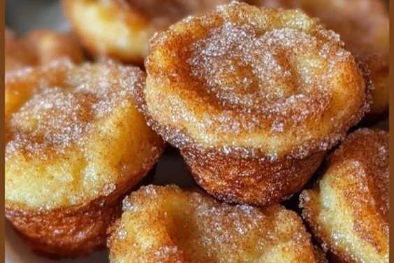 Cinnamon Roll French Toast Bites on a plate, drizzled with icing.