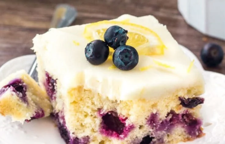 Delicious homemade Lemon Blueberry Cake on a rustic wooden table